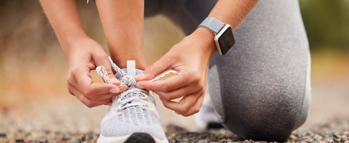 a sports woman tying her laces before training, running or a workout.